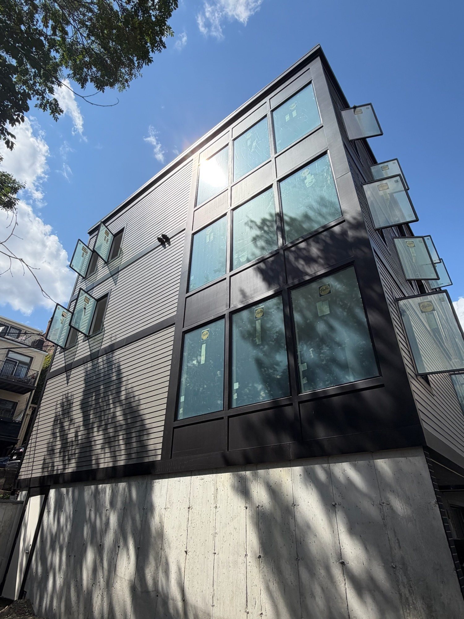 Stacked glass bays on the rear of 421 East Sixth, showing three living levels