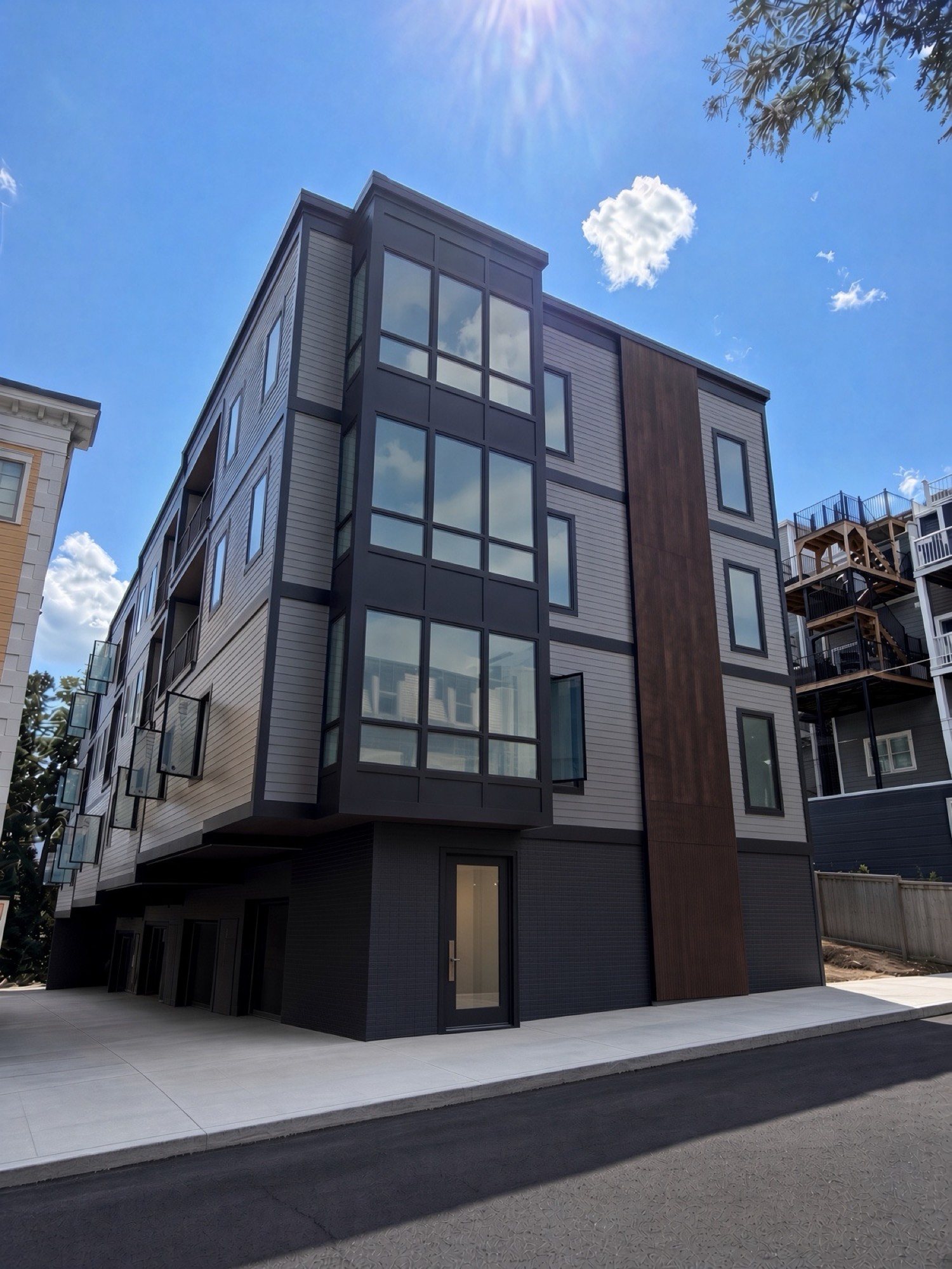 Finished corner of 421 East Sixth with sidewalk, entry, and garage level
