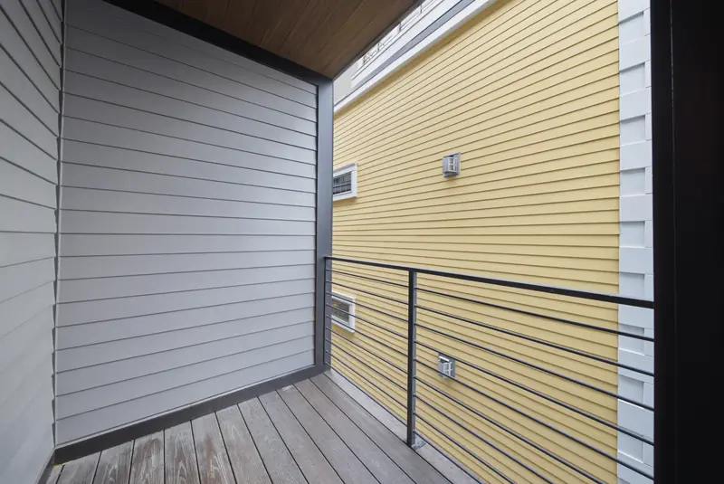 Covered bedroom deck with metal railing at Residence 3, 421 East Sixth, South Boston