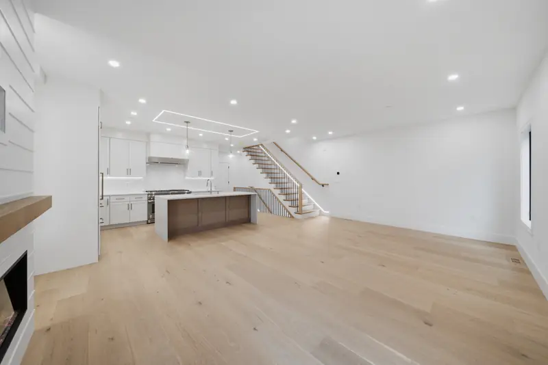 Open living level with kitchen island and stair at Residence 3, 421 East Sixth, South Boston