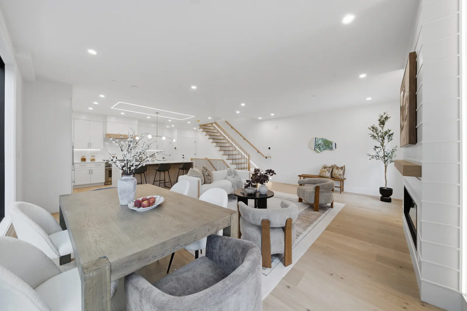 Finished dining area, kitchen island, and stair on the open living level at Residence 4, 421 East Sixth