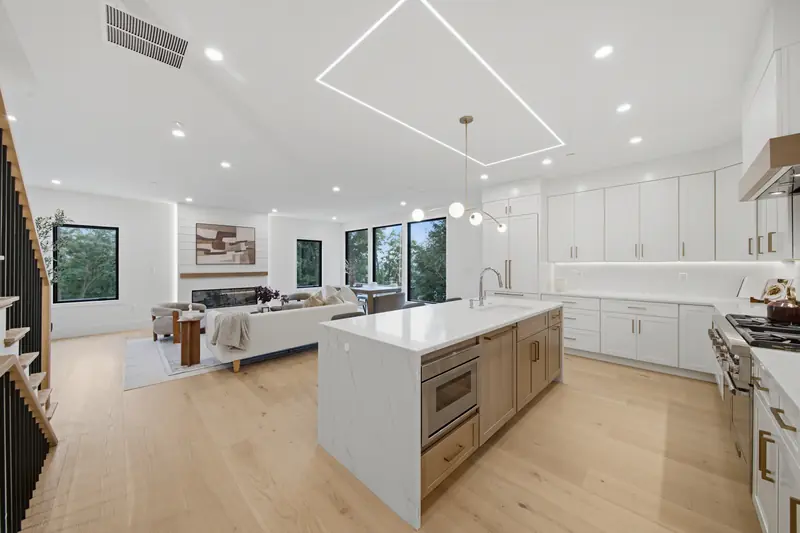 Kitchen island open to the living room and electric fireplace at Residence 4, 421 East Sixth, South Boston