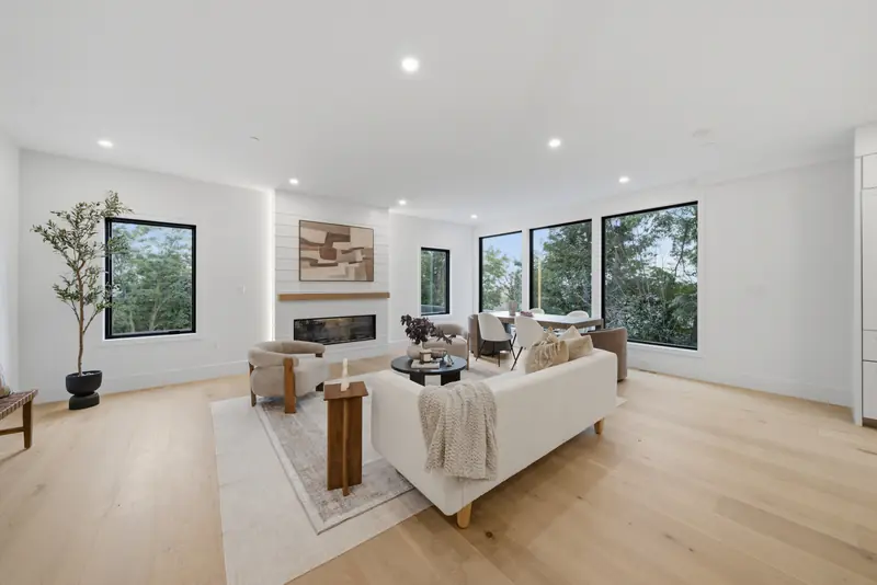Living room with electric fireplace and black-framed windows at Residence 4, 421 East Sixth, South Boston