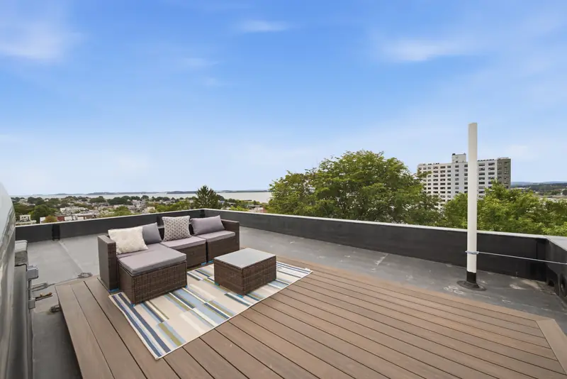 Private roof deck with composite decking and outdoor seating at Residence 4, 421 East Sixth, South Boston