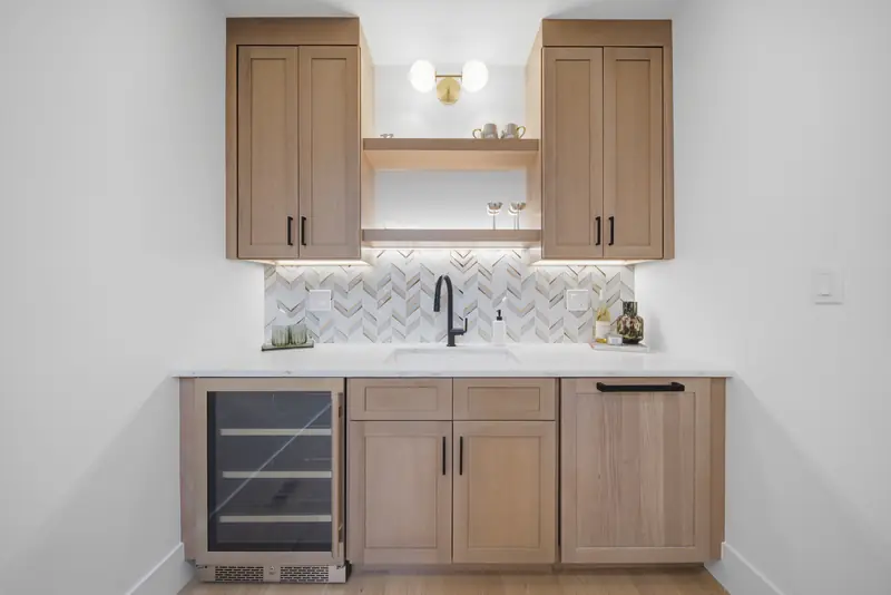 Built-in wet bar with wine refrigerator and wood cabinetry at Residence 4, 421 East Sixth, South Boston
